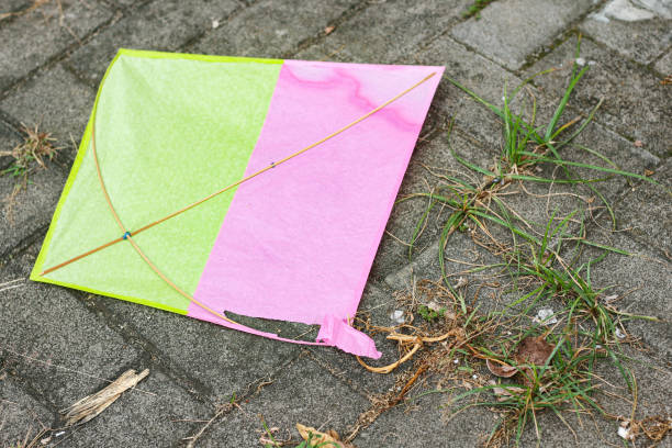 yellow, pink kites torn on the streets