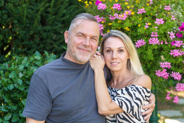 istock Happy middle aged couple posing arm in arm 1431636291