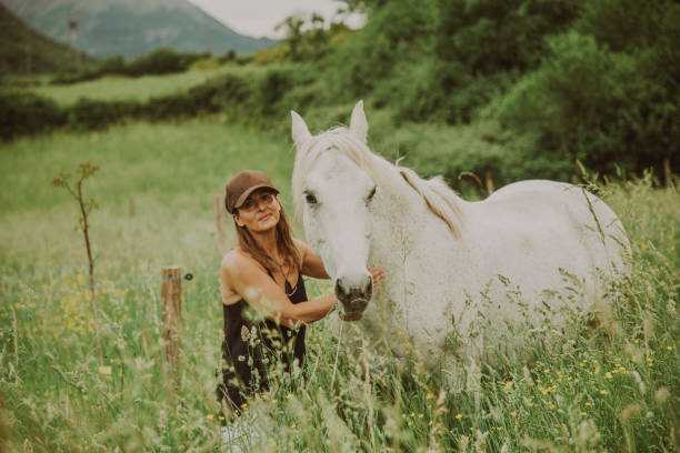 istock Woman with a white horse 1431637036