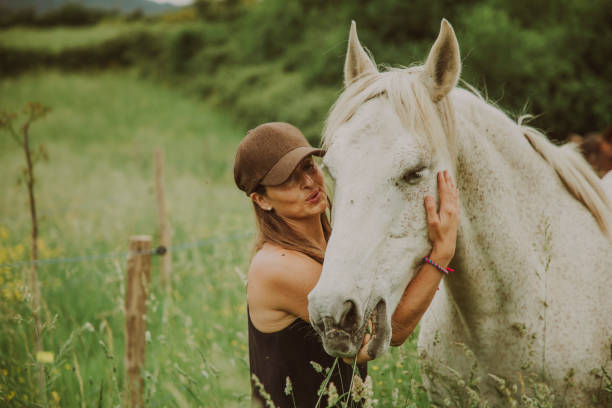 istock Woman with a white horse 1431637041