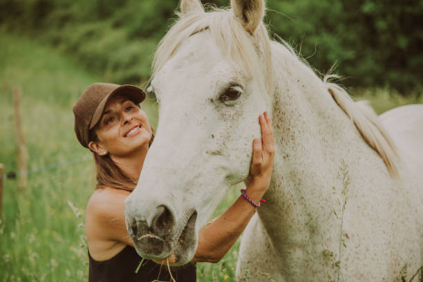 istock Woman with a white horse 1431637043
