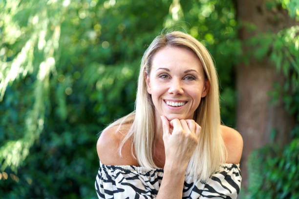 istock Vivacious blond woman laughing at the camera 1431637878
