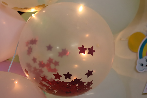 decorative closeup of balloon with red star filled inside for background and greeting cards