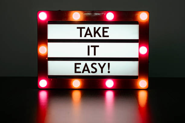 istock Lightbox with red lights in dark room with phrase- take it easy. 1431643173
