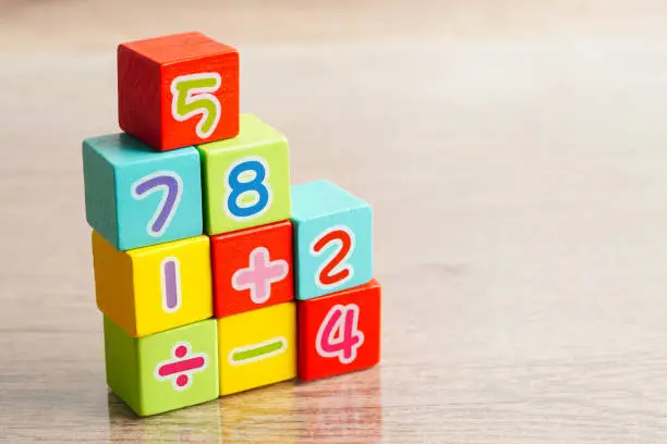 Photo of Number wood block cubes for learning Mathematic, education math concept.