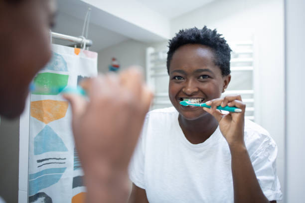 istock Happy woman brushing teeth 1431648765
