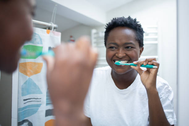 istock Happy woman brushing teeth 1431648768