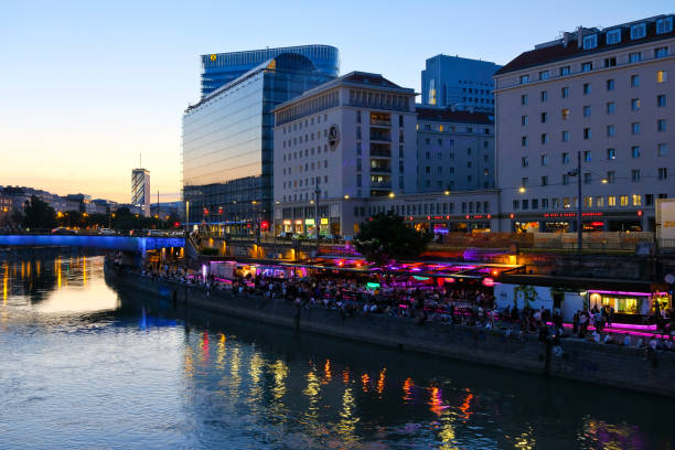Vienna, Austria - June 17, 2022: View down to the Danube Canal. On the banks are numerous hip restaurants, bars and clubs. In the summer months, the meeting place for party people.
