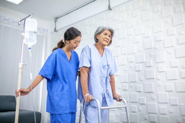 Asian nurse assisting senior patient trying to walk with saline at hospital, Healthcare and medicine concept. Asian nurse assisting senior patient trying to walk with saline at hospital, Healthcare and medicine concept. walking aide stock pictures, royalty-free photos & images