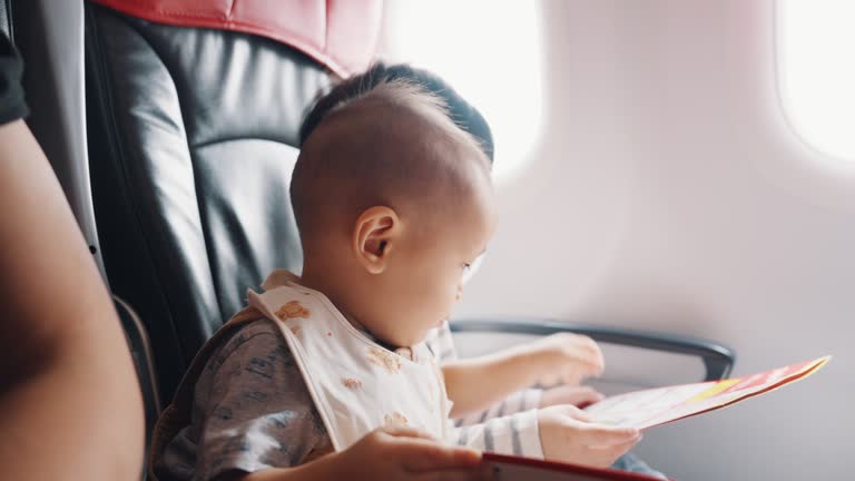 Asian parent with two sons traveling by commercial plane