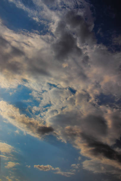 istock thick white cumulus clouds, flanked by gray-shaded cloud tufts, under a twilight blue sky. 1431654111