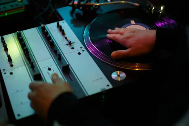Professional retro turntables and sound mixers on hip hop party in night club
