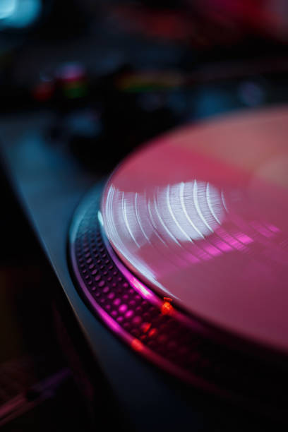 istock White vinyl record with music on turntable. Analog audio disc on turn table. DJ equipment on party in night club. Listen to the music in hi fi 1431658615
