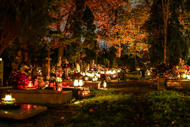 istock Christian cemetery with lit grave lights at night. Graveyard on All Saints' Day. 1431684470