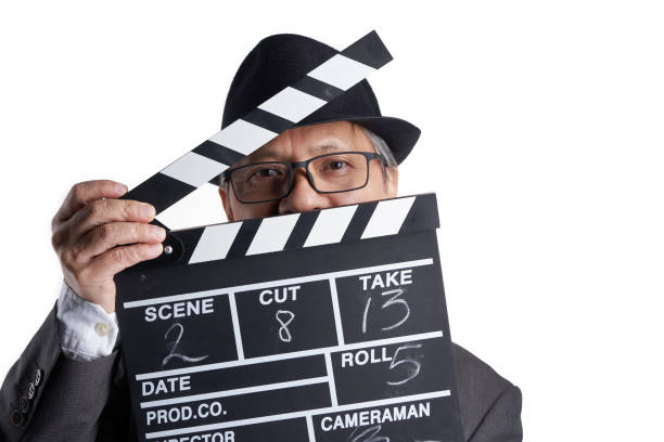 film director holding clapper board against white background
