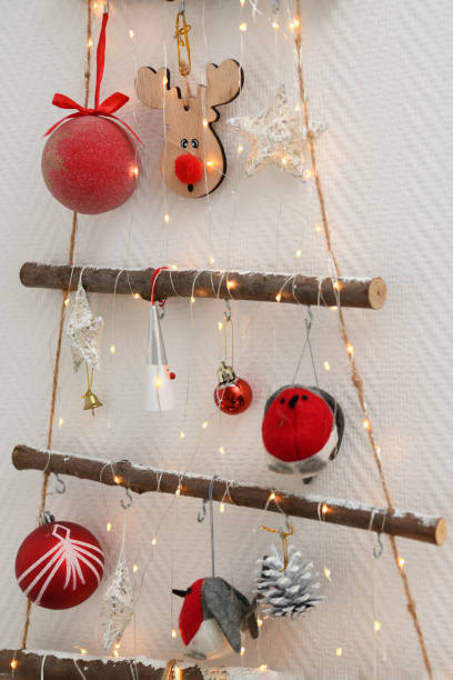 istock Handmade wooden Christmas tree hanging on the wall 1431691102
