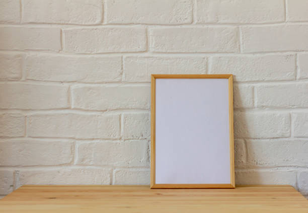 istock Empty photo frame in a wooden frame on a wooden table with copy space. 1431691425