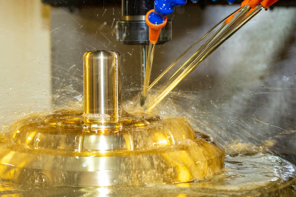 istock The CNC milling machine cutting the brass material part with oil coolant method. 1431693664