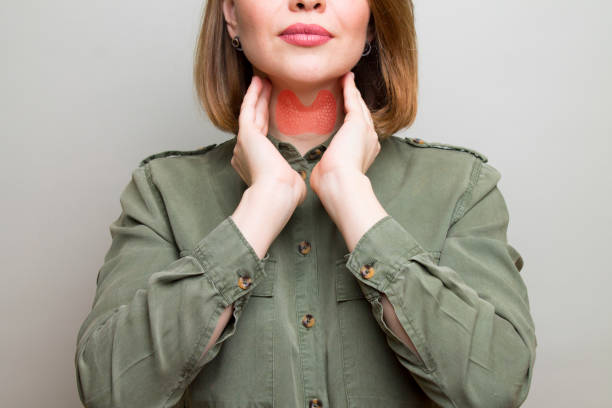 Female checking thyroid gland by herself. Thyroid disorder includes goiter, hyperthyroid, hypothyroid, tumor or cancer. Health care Female checking thyroid gland by herself. Thyroid disorder includes goiter, hyperthyroid, hypothyroid, tumor or cancer. Health care thyroid disease stock pictures, royalty-free photos & images