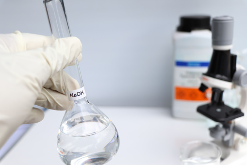 sodium hydroxide in glass, chemical in the laboratory and industry, corrosive chemical