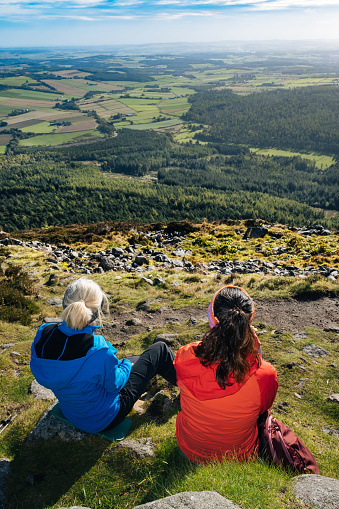 Mother and step-daughter relaxing after a climb to the summit of Bennachie in Aberdeenshire, Scotland.