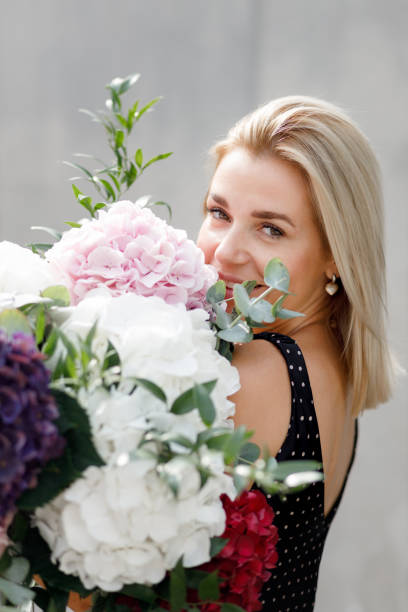 istock A young woman is holding a large bouquet of hydrangeas 1431698096
