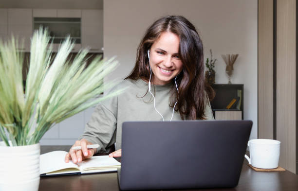 istock Brown hair woman working from home participating at video call using her laptop. 1431698870
