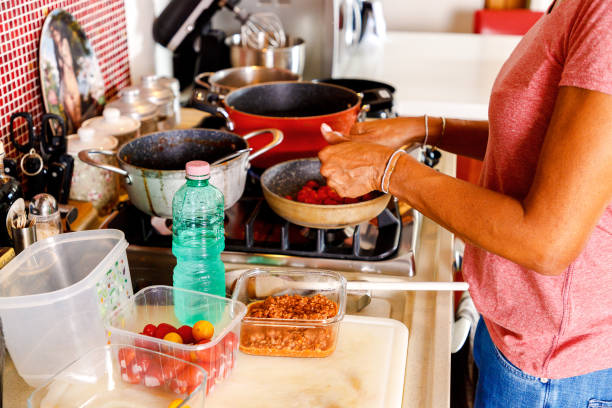 istock Close-up of woman's hands preparing lunch, reusing some previously cooked food 1431705458