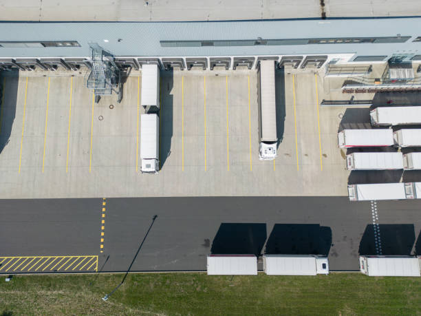 istock Aerial view of a large distribution warehouse with loading docks trucks 1431707178
