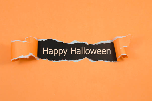 istock Happy Halloween written under torn paper. 1431707609