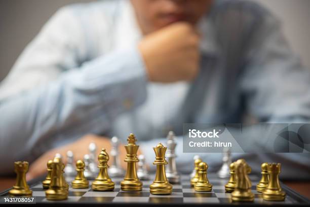 Premium Photo  Person playing chess board game, conceptual image of  businesswoman holding chess pieces against opponent chess against business  competition, planning business strategies to defeat business competitors