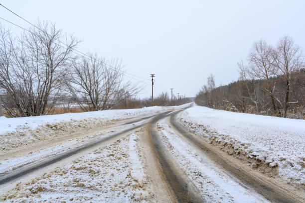 Snowy winter road in a mountain forest. Beautiful winter landscape.