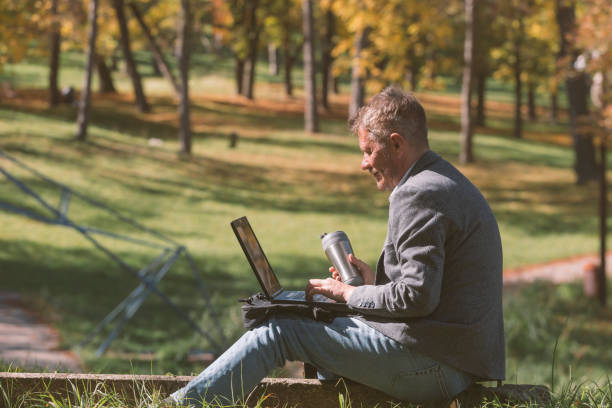 istock Man working on laptop outdoors 1431715072