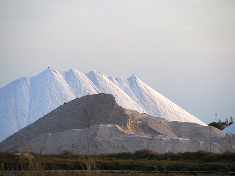 Large mountains of salt at sunset. The landscape of a natural salt lake in Spain.