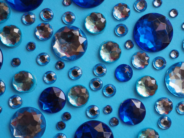 Dark blue shiny rhinestones on a light blue background. For design or splash screen.