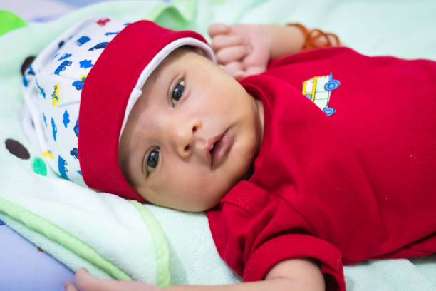 istock cute newborn baby looking at camera in red dress from different angle 1431719254