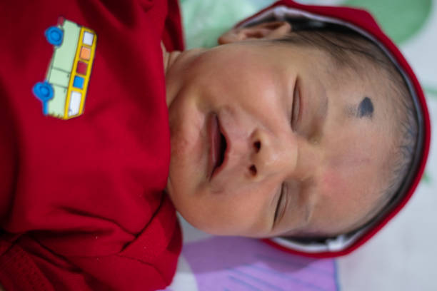 istock cute newborn baby crying expression red dress from different angle 1431720486