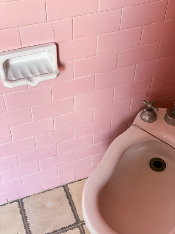 Vintage bathroom with bubbleglum pink tile and white bidet