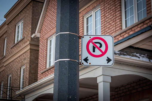 No parking sign attached to a pole on a street in Toronto