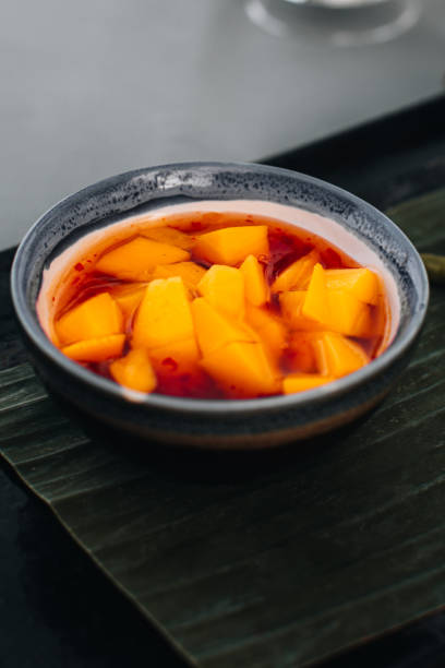 istock Thai spicy sauce with fresh mango pieces and chili 1431723470