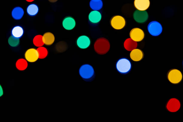 istock Clorful blurred lighs bokeh on black background as a festive backdrop 1431724341