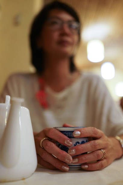 istock Asian Woman Drinking Greem Tea in a restaurant 1431725761