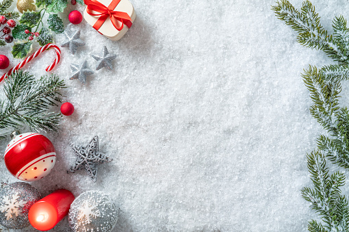 Christmas background winter snow and fir tree with baubles and candles Christmas lights, gift box, candy cane, snowflakes, christmas tree, directly above view flatlay