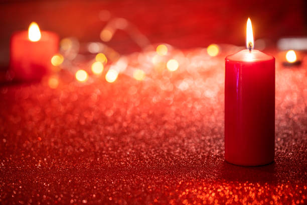 istock Red candle light Christmas candlelight on glowing flame sparklin 1431727415