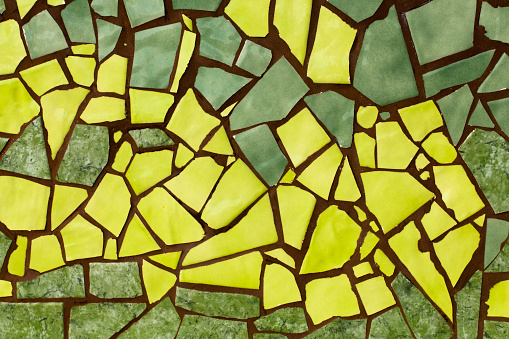 Broken green and yellow tiles , wall or flooring decoration