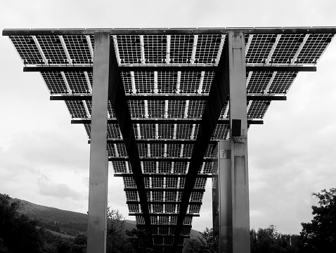 street view of elevated solar panels, on a structure above the Adige River in downtown Trento, Italy, Trentino-Alto Adige, Tyrol