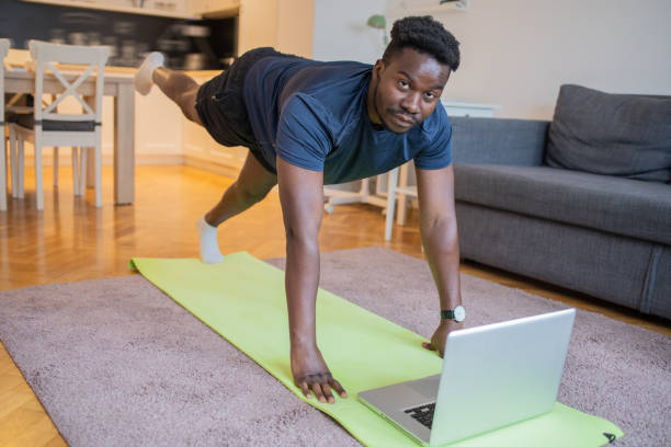 istock Man at home keeping fit by exercising 1431733640