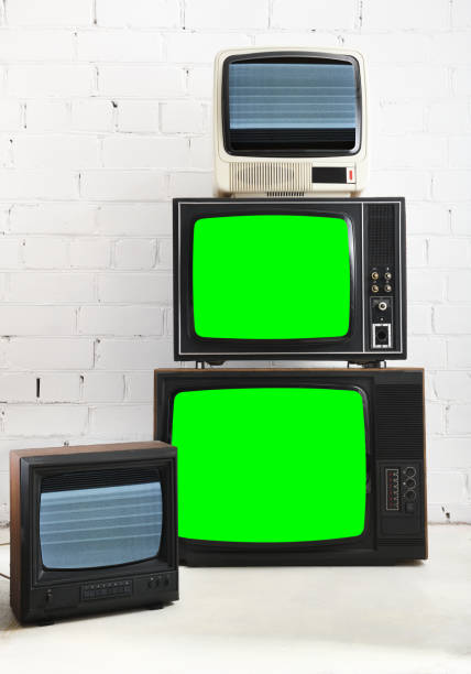 istock Four vintage green screen televisions with a white brick background. 1431735046
