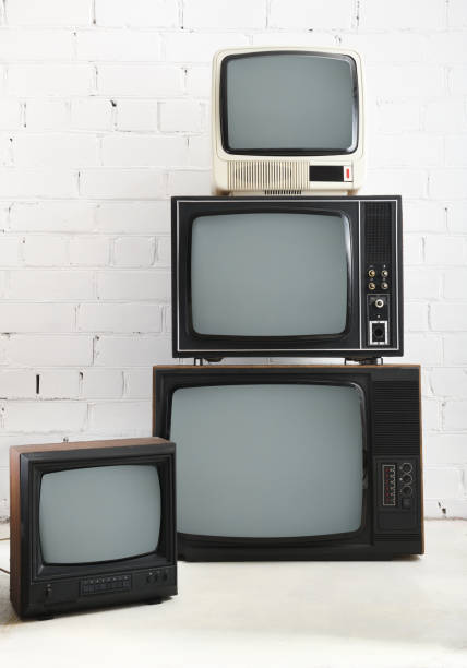 istock Four old TVs stand against a background of white brick. 1431735089