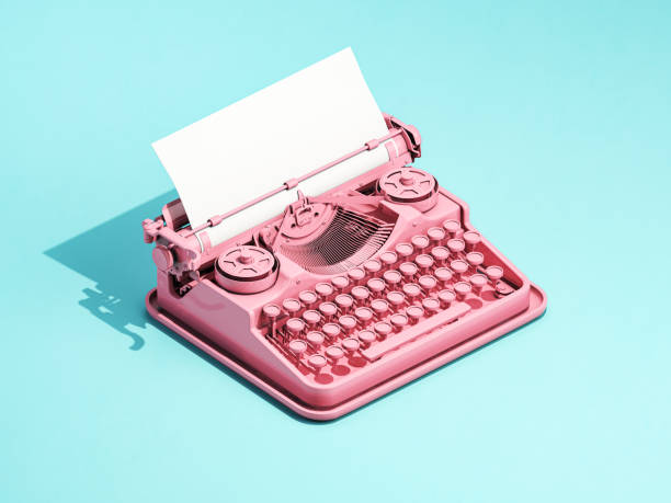 Vintage pink typewriter on blue background with space for text. stock photo